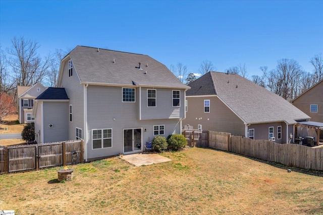 back of property featuring a fenced backyard, a yard, and a patio