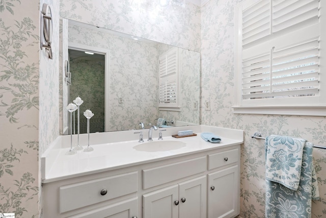 bathroom featuring vanity and wallpapered walls