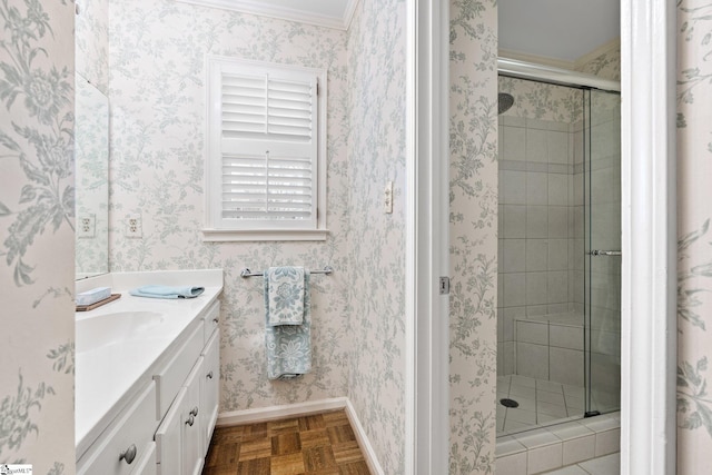 bathroom featuring baseboards, a stall shower, vanity, and wallpapered walls