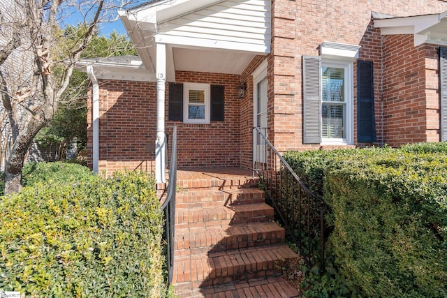 property entrance featuring brick siding