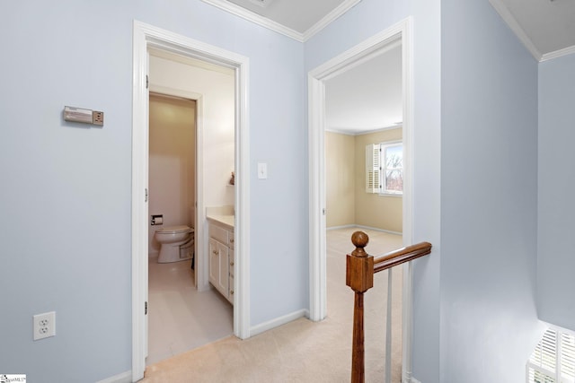 hall with light colored carpet, visible vents, baseboards, attic access, and crown molding