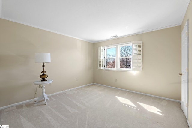 unfurnished room with light carpet, ornamental molding, visible vents, and baseboards