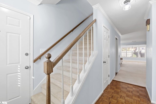 stairs featuring baseboards and crown molding