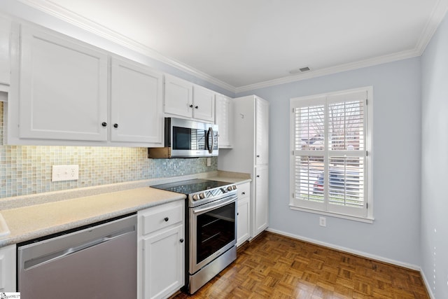 kitchen with stainless steel appliances, backsplash, visible vents, and white cabinetry