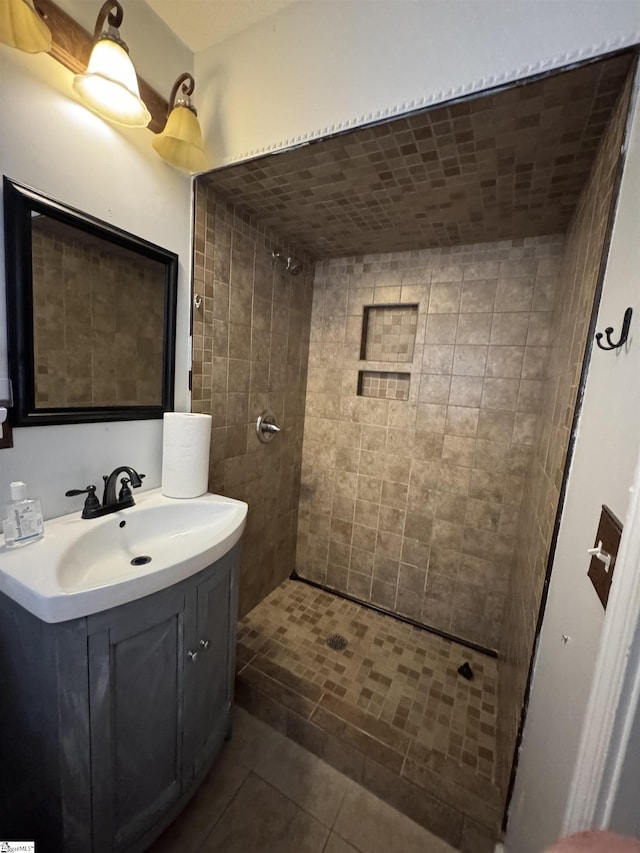 full bathroom with vanity, tile patterned floors, and a tile shower