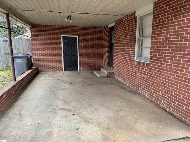 view of patio / terrace featuring a carport and fence