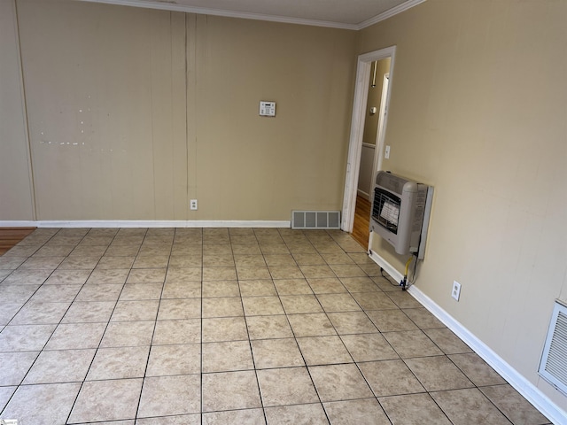 interior space featuring visible vents, baseboards, ornamental molding, light tile patterned floors, and heating unit