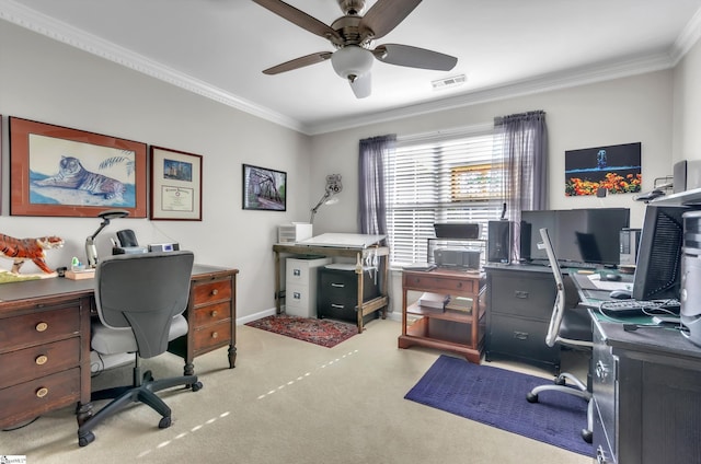 carpeted office featuring visible vents, baseboards, ornamental molding, and a ceiling fan