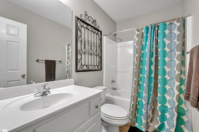 bathroom with toilet, vanity, and shower / bath combo