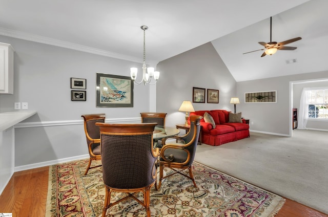 dining area featuring visible vents, ornamental molding, ceiling fan with notable chandelier, baseboards, and vaulted ceiling