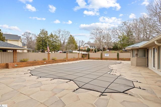 view of swimming pool featuring a residential view, a patio, and fence