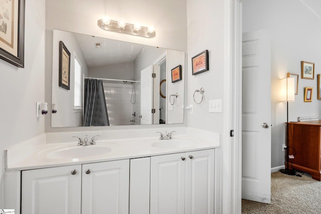 bathroom with double vanity, a shower with curtain, and a sink