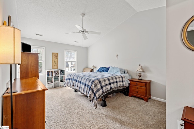 bedroom featuring visible vents, light colored carpet, and vaulted ceiling