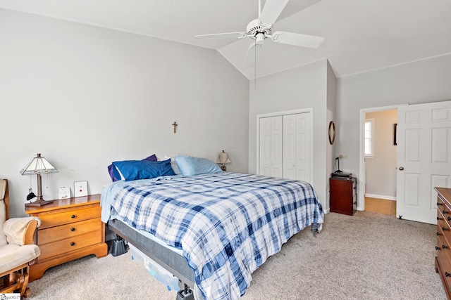 bedroom featuring a closet, light carpet, a ceiling fan, and vaulted ceiling