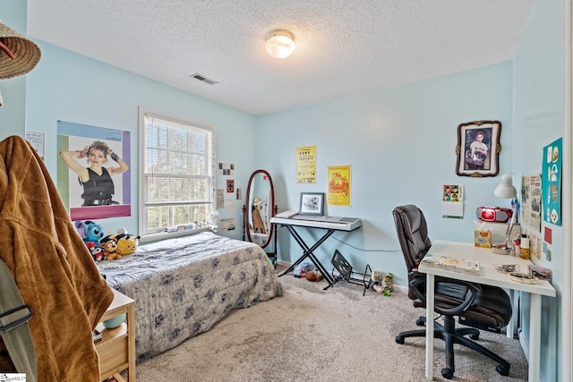 carpeted bedroom with baseboards, visible vents, and a textured ceiling