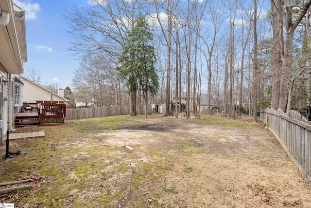 view of yard with a fenced backyard and a deck