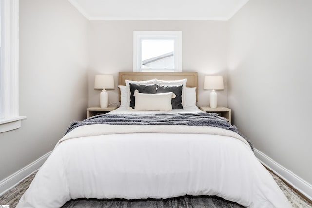 bedroom with baseboards and ornamental molding