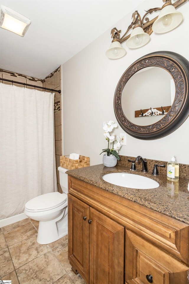 full bathroom with vanity, a shower with shower curtain, and toilet