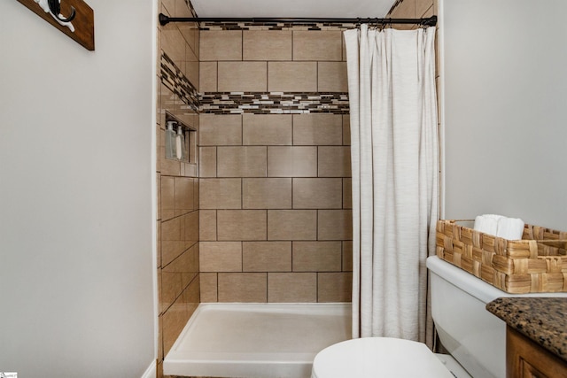 bathroom with toilet, a stall shower, and vanity