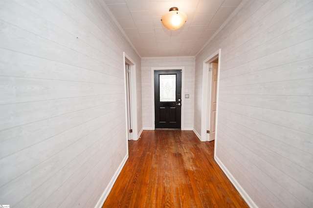 doorway to outside with baseboards and dark wood-style flooring