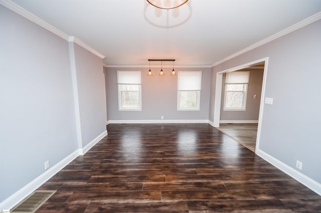 spare room with baseboards, dark wood finished floors, and crown molding