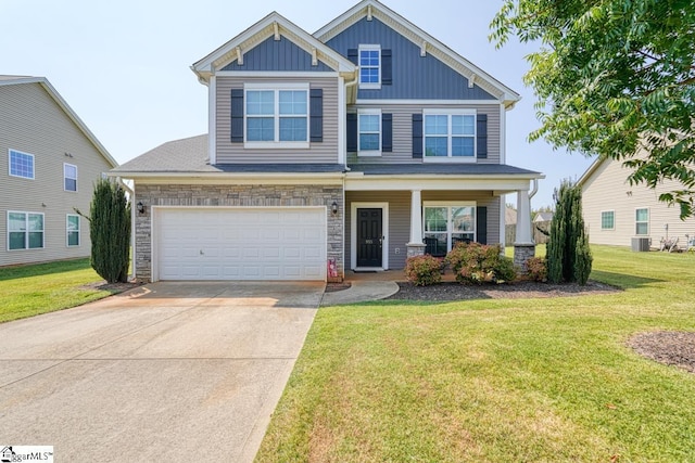 craftsman inspired home with driveway, an attached garage, board and batten siding, and a front yard