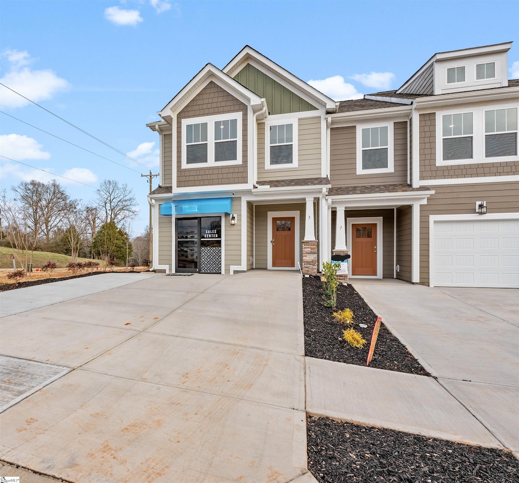 view of front of property featuring a garage, board and batten siding, and driveway