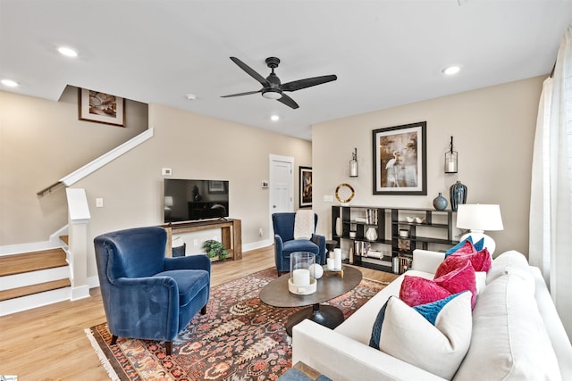 living area with stairway, recessed lighting, wood finished floors, and baseboards