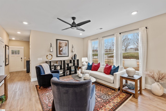 living room featuring recessed lighting, visible vents, baseboards, and light wood-style flooring