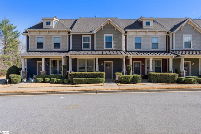 view of front of home with metal roof, a porch, and a standing seam roof