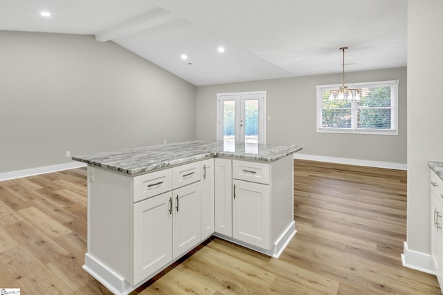 kitchen featuring white cabinetry, light wood-style floors, baseboards, and french doors