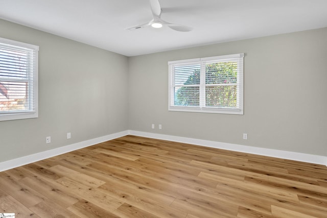 spare room with light wood-style flooring, baseboards, and ceiling fan