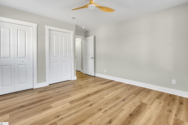 unfurnished bedroom featuring light wood-style flooring, baseboards, visible vents, and ceiling fan