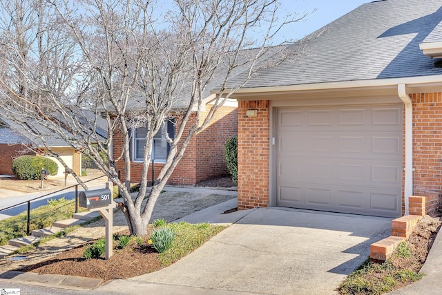 exterior space featuring a garage, brick siding, driveway, and a shingled roof