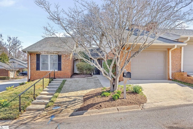 view of front of house with concrete driveway, a garage, brick siding, and a shingled roof