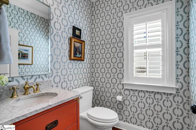 bathroom featuring a wealth of natural light, toilet, and wallpapered walls
