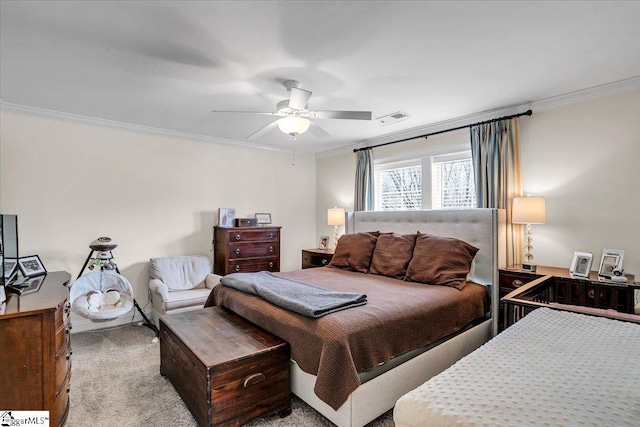 carpeted bedroom with visible vents, ornamental molding, and a ceiling fan