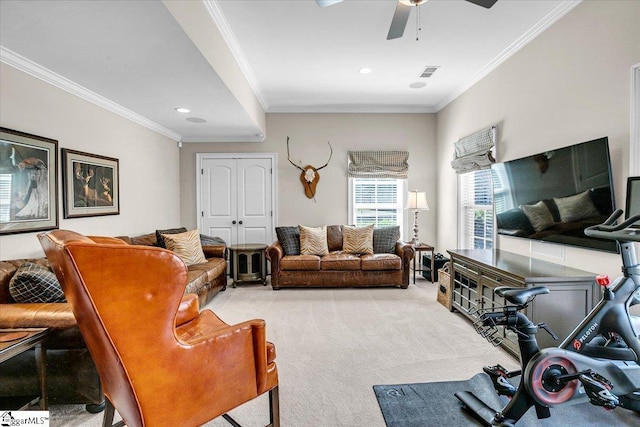 carpeted living room with crown molding, a ceiling fan, and visible vents