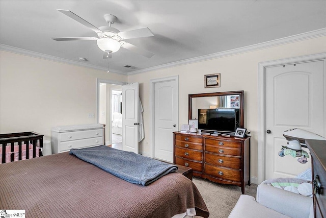carpeted bedroom featuring visible vents, crown molding, and a ceiling fan