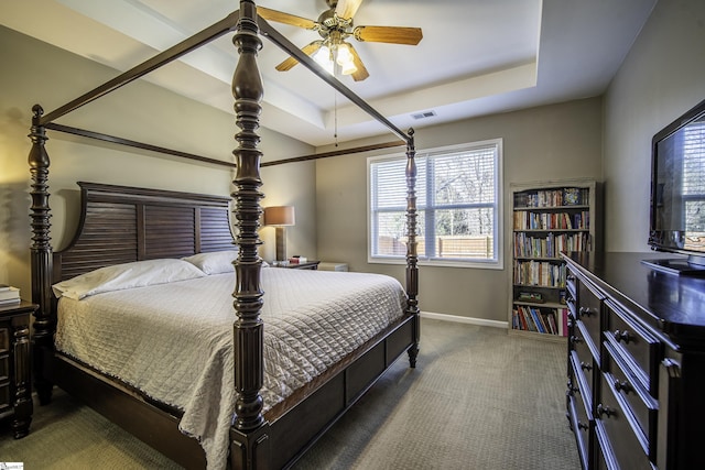 bedroom featuring visible vents, ceiling fan, carpet, baseboards, and a raised ceiling