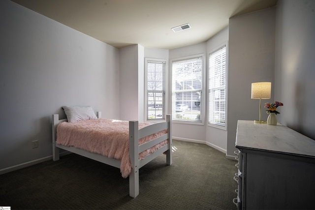 bedroom featuring visible vents, baseboards, and dark carpet