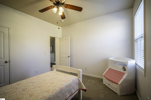 bedroom with a ceiling fan, baseboards, and dark carpet