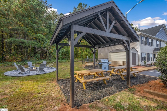 exterior space featuring a gazebo, an outdoor structure, a fire pit, a storage shed, and a patio area