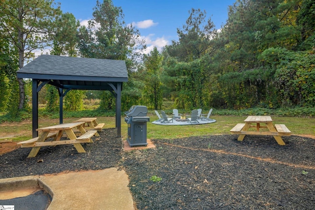 view of yard featuring a patio, a gazebo, and an outdoor fire pit