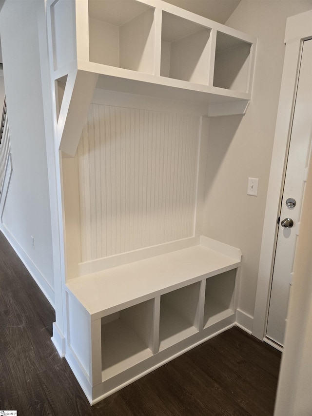 mudroom with dark wood-style floors and baseboards