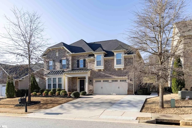 view of front of house featuring brick siding, an attached garage, driveway, and a standing seam roof