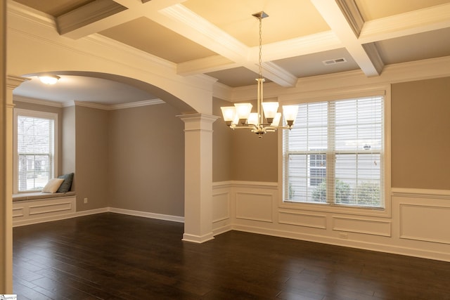 unfurnished dining area featuring decorative columns, dark wood-type flooring, visible vents, and beamed ceiling