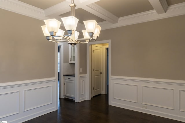 unfurnished dining area with beamed ceiling, a notable chandelier, dark wood-style floors, and ornamental molding