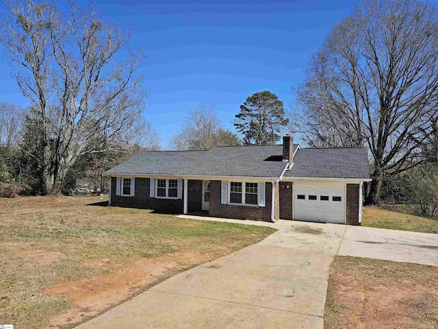 ranch-style home with brick siding, an attached garage, a front yard, a chimney, and driveway