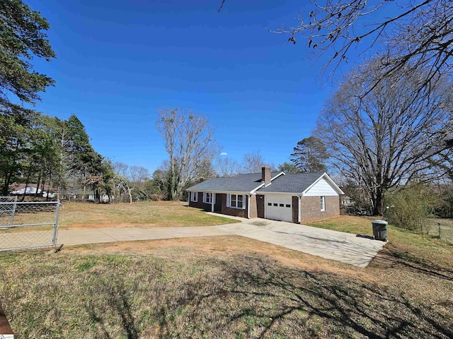 single story home featuring driveway, a front yard, a garage, brick siding, and a chimney